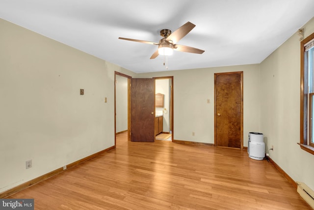 7000 Burch Hill Rd, Brandywine, MD 20613 - spare room with baseboard heating, ceiling fan, light wood finished floors, and baseboards