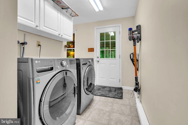 7000 Burch Hill Rd, Brandywine, MD 20613 - laundry area featuring cabinet space, light tile patterned flooring, washing machine and clothes dryer, and baseboards