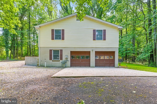7000 Burch Hill Rd, Brandywine, MD 20613 - view of front of house with a garage, driveway, and stucco siding