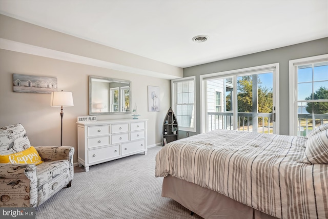 bedroom with baseboards, access to outside, light colored carpet, and visible vents