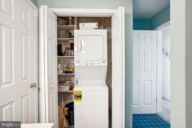laundry area featuring stacked washing maching and dryer and laundry area