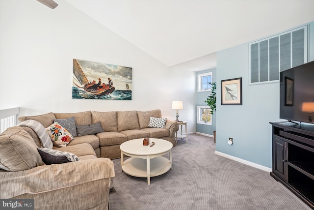 carpeted living area featuring baseboards and lofted ceiling