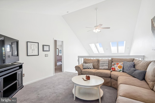 living area with light colored carpet, high vaulted ceiling, baseboards, a skylight, and a ceiling fan