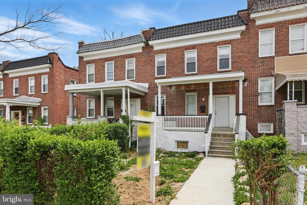 4137 Fairview Ave, Baltimore, MD 21216 - townhome / multi-family property with a tiled roof and brick siding