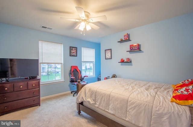carpeted bedroom with baseboards, visible vents, and ceiling fan