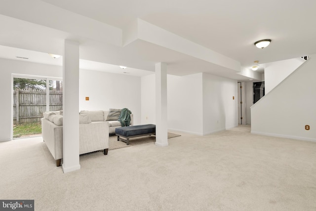 living room featuring light carpet and baseboards