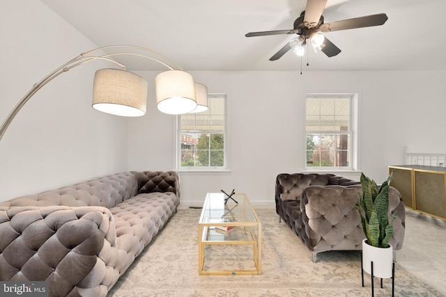 living room featuring carpet flooring and a ceiling fan