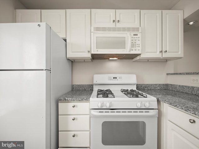 kitchen with white appliances and white cabinetry