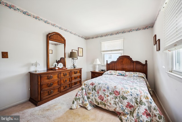carpeted bedroom featuring baseboards