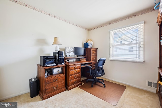 carpeted home office featuring visible vents and baseboards