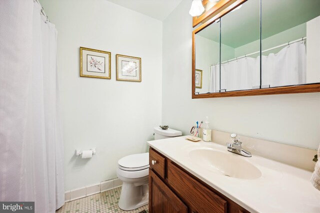 bathroom featuring toilet, baseboards, tile patterned floors, and vanity