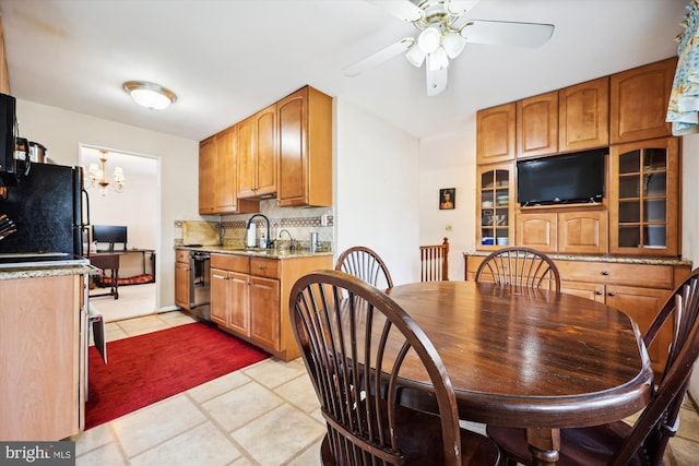 dining area with light tile patterned flooring and ceiling fan with notable chandelier