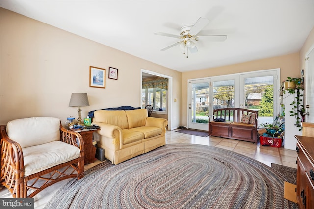 living room featuring light tile patterned floors and ceiling fan