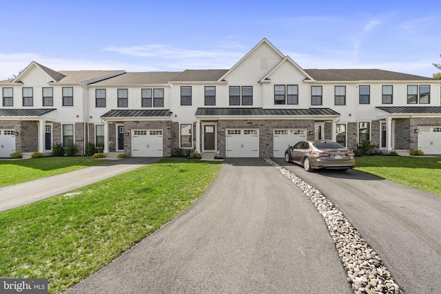 multi unit property with a standing seam roof, an attached garage, driveway, and a front lawn