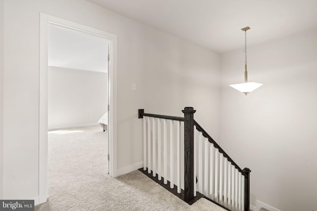 stairs featuring baseboards and carpet