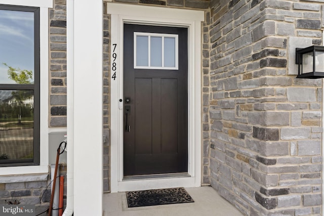 property entrance with stone siding