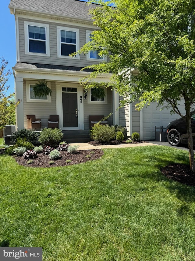 view of front of home featuring central AC unit, an attached garage, a shingled roof, and a front lawn
