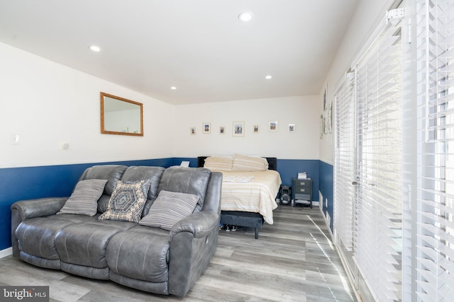 bedroom featuring baseboards, light wood-style floors, and recessed lighting