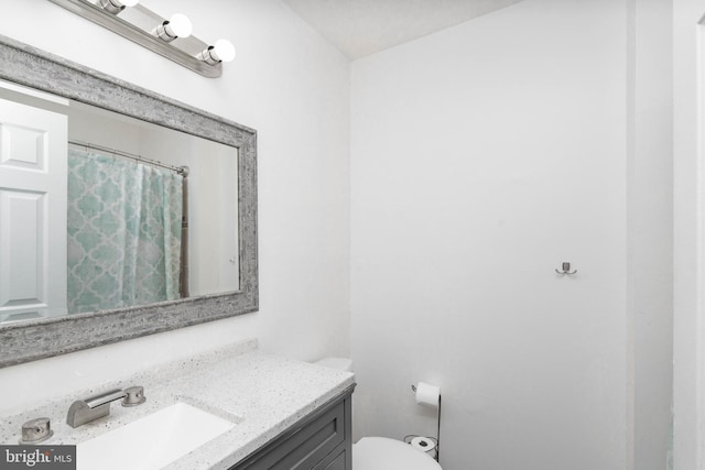 full bath featuring toilet and vanity