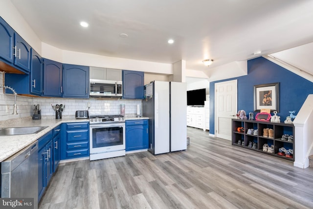 kitchen with blue cabinets, a sink, light wood-type flooring, and appliances with stainless steel finishes