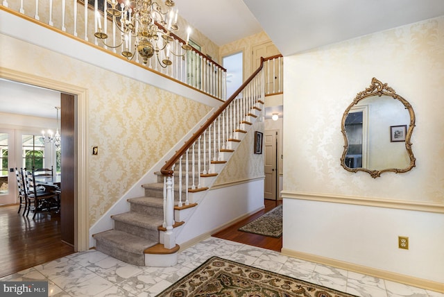 4300 Valleyview Rd, Harrisburg, PA 17112 - staircase featuring a chandelier, baseboards, wood finished floors, and french doors