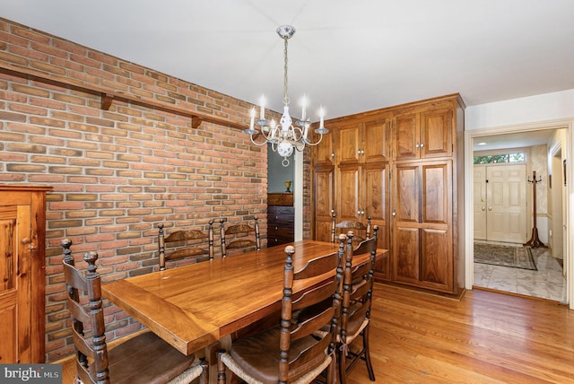 4300 Valleyview Rd, Harrisburg, PA 17112 - dining space with light wood finished floors, a chandelier, and brick wall