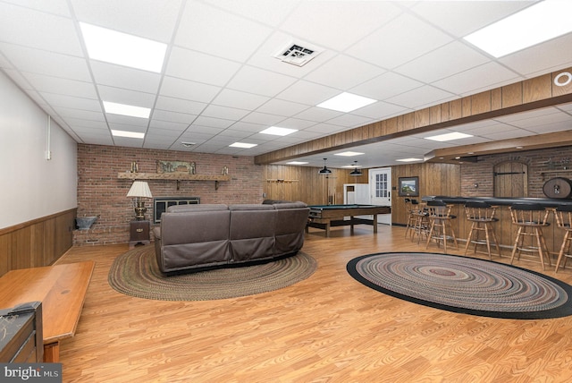 4300 Valleyview Rd, Harrisburg, PA 17112 - living area with wood finished floors, wooden walls, a drop ceiling, wainscoting, and a brick fireplace