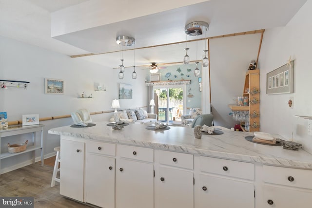 2818 Tern Dr Unit 9, Ocean City, MD 21842 - kitchen featuring white cabinetry, light countertops, a peninsula, and open floor plan