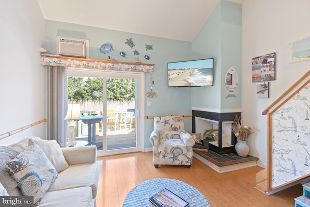 2818 Tern Dr Unit 9, Ocean City, MD 21842 - living area featuring lofted ceiling, wood finished floors, a wall unit AC, and a tile fireplace