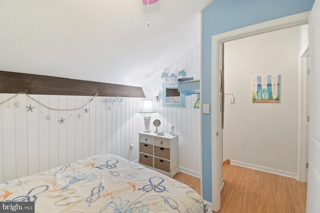 2818 Tern Dr Unit 9, Ocean City, MD 21842 - bedroom with baseboards, lofted ceiling, light wood-style floors, and a textured ceiling