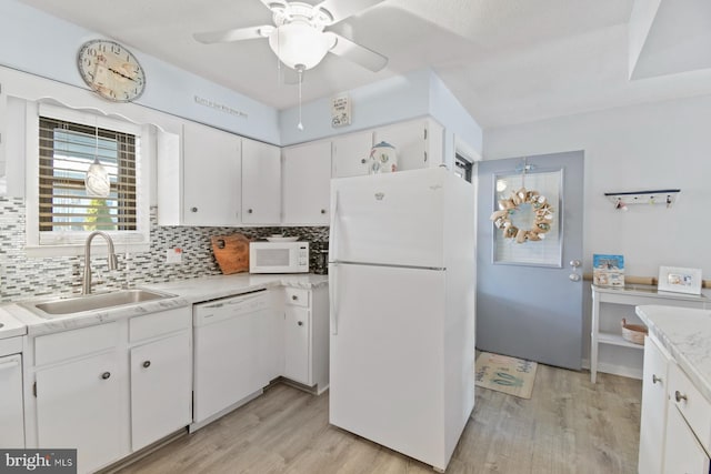2818 Tern Dr Unit 9, Ocean City, MD 21842 - kitchen with light wood finished floors, white appliances, tasteful backsplash, and a sink