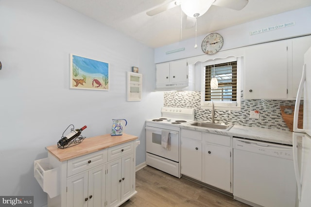2818 Tern Dr Unit 9, Ocean City, MD 21842 - kitchen with decorative backsplash, light countertops, white appliances, white cabinetry, and a sink