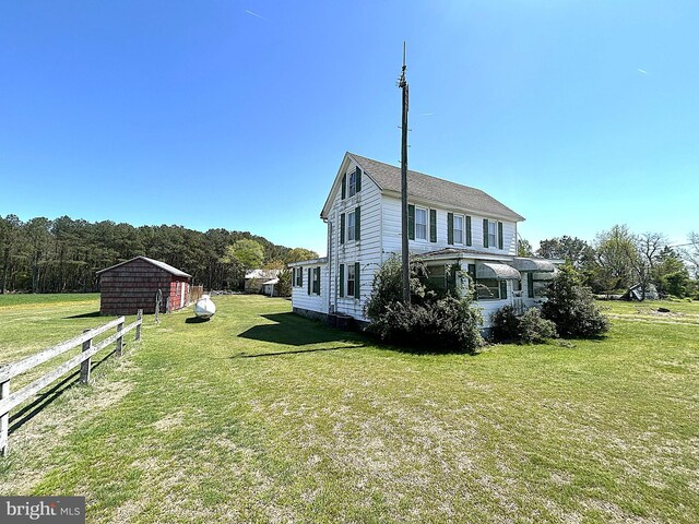 6637 Elton Dennis Rd, Willards, MD 21874 - view of side of home featuring a lawn, an outdoor structure, and fence