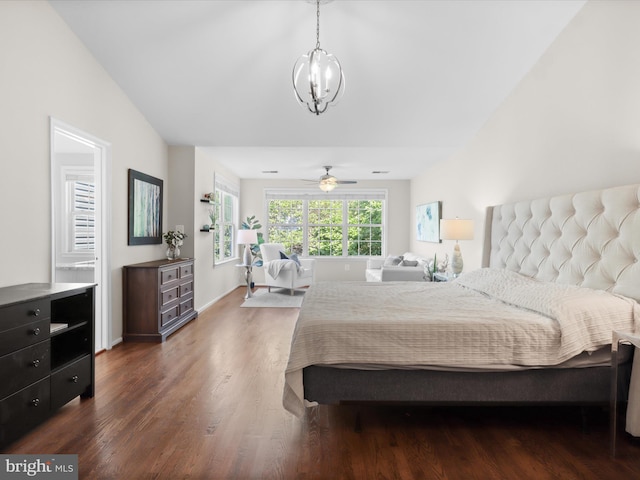 bedroom with wood finished floors and a chandelier