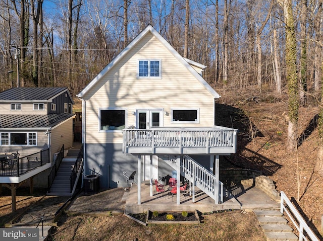 rear view of property featuring a patio, a wooden deck, stairway, and central AC unit