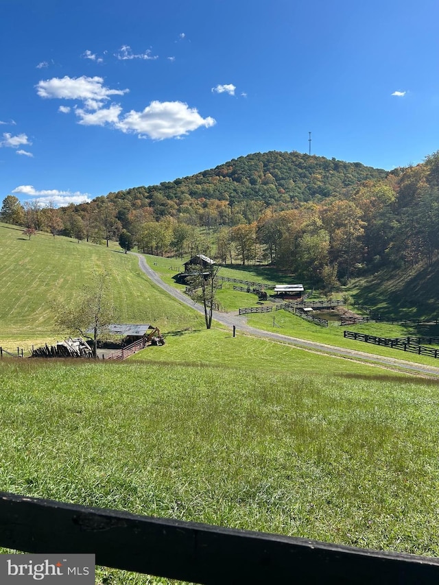 view of mountain feature with a view of trees and a rural view