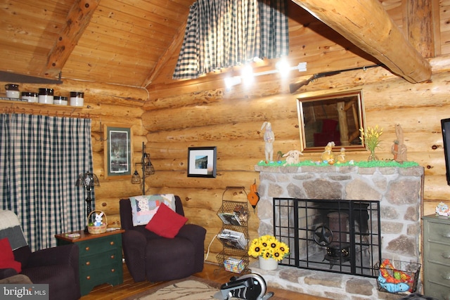 living area featuring wooden ceiling, lofted ceiling with beams, and a stone fireplace