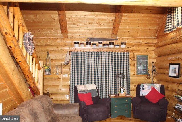 sitting room featuring lofted ceiling with beams and wooden ceiling