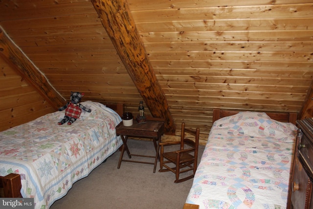 unfurnished bedroom with vaulted ceiling, wooden walls, and carpet floors