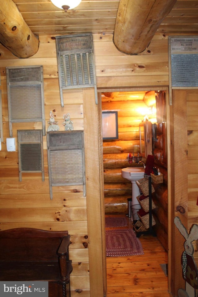 bathroom with wood-type flooring, wooden ceiling, and rustic walls