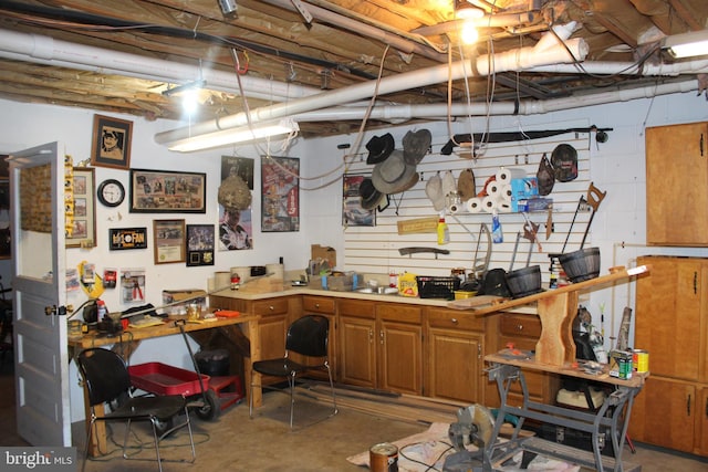 unfinished below grade area featuring a workshop area