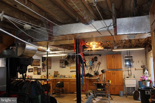 below grade area with a sink and a workshop area