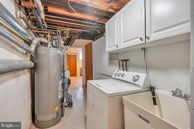 washroom featuring water heater, cabinet space, washer / clothes dryer, and a sink