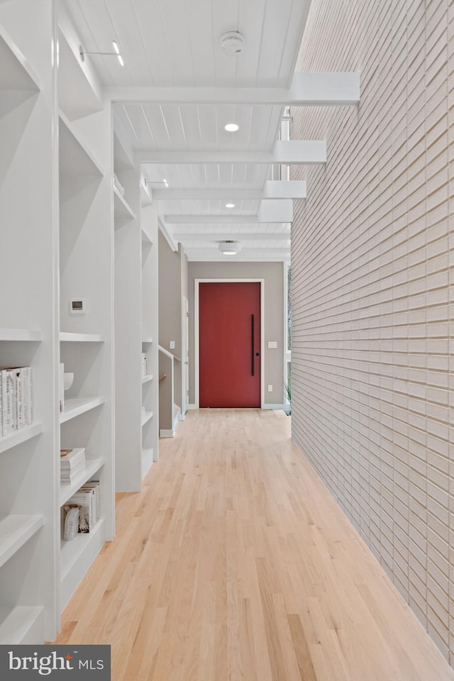 7030 Oregon Ave NW, Washington, DC 20015 - hallway with an accent wall, wood finished floors, and built in shelves
