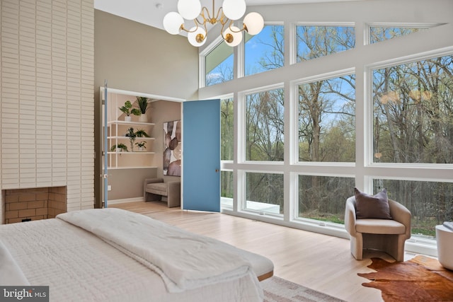 7030 Oregon Ave NW, Washington, DC 20015 - bedroom with a chandelier, wood finished floors, a towering ceiling, and ensuite bathroom