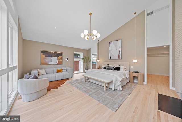 7030 Oregon Ave NW, Washington, DC 20015 - bedroom with an inviting chandelier, wood finished floors, a walk in closet, baseboards, and high vaulted ceiling