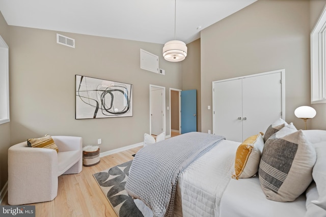 7030 Oregon Ave NW, Washington, DC 20015 - bedroom featuring a towering ceiling, wood finished floors, visible vents, a closet, and baseboards