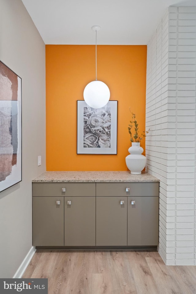 7030 Oregon Ave NW, Washington, DC 20015 - details featuring an accent wall, wood finished floors, and baseboards