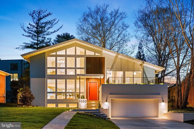 7030 Oregon Ave NW, Washington, DC 20015 - view of front facade with concrete driveway, an attached garage, and brick siding