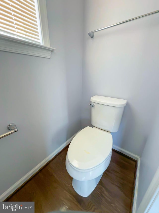 bathroom featuring baseboards, toilet, and wood finished floors